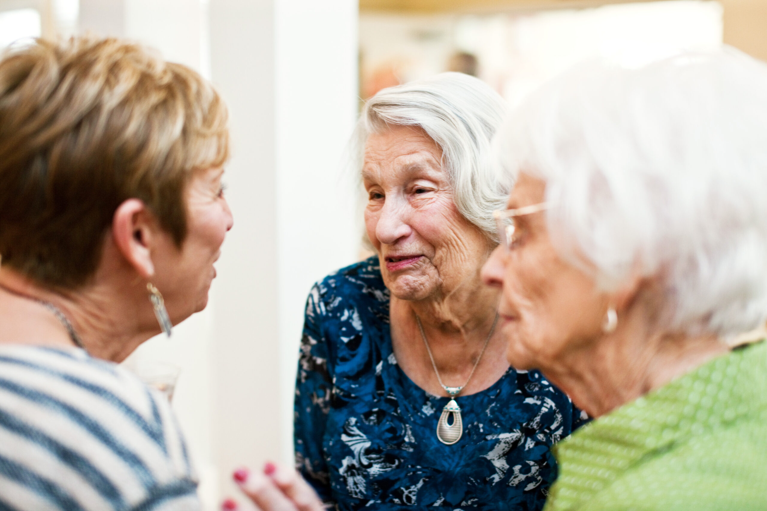 Elderly friends talking to one another