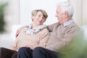 elderly couple looking at each other smiling